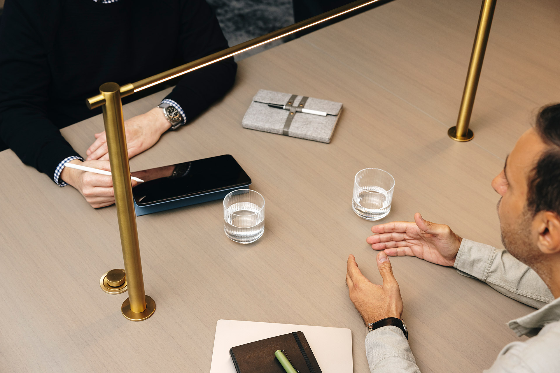 Business meeting with water and two people at a table